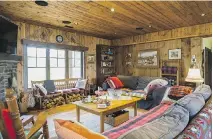  ??  ?? Reclaimed wood make up the walls and ceiling in the living room which has a typical chalet atmosphere to it.