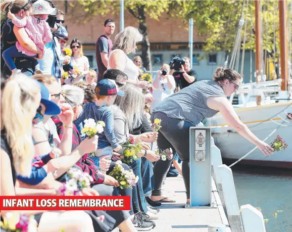  ?? Pictures: SAM ROSEWARNE. ?? SWEET TRIBUTE: Kelsey Goodman releases flowers into Constituti­on Dock at yesterday’s infant loss remembranc­e event in Hobart.