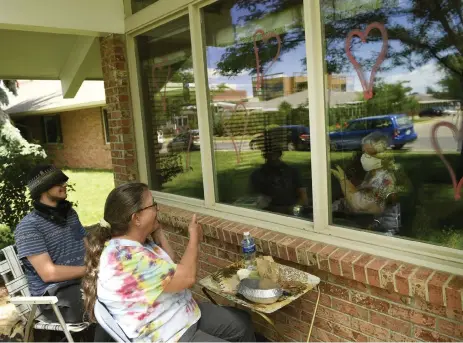  ?? Helen H. Richardson, The Denver Post ?? Fairacres Manor resident Sharon Peterson, inside, has a visit and shares lunch with her sister Kat Nelson, center, and her nephew Brandon Branan, left, on June 10 at at the facility in Greeley.