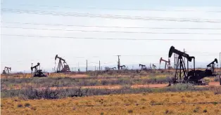  ?? ASSOCIATED PRESS FILE PHOTO ?? Pump jacks in the Loco Hills field in 2014 in Eddy County, near Artesia, one of the most active regions of the Permian Basin.