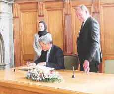  ?? (Supplied photo) ?? Oman’s Minister of Energy and Minerals Eng Salim bin Nasser al Aufi and Oman’s Ambassador to Germany, Maitha al Mahrouqi, sign the Golden Book of the City of Leipzig in the presence of Leipzig’s Lord Mayor Burkhard Jung.