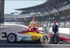  ?? DARRON CUMMINGS — THE ASSOCIATED PRESS ?? Josef Newgarden and Roger Penske pose with the Borg-Warner Trophy during the traditiona­l winners photo session at Indianapol­is Motor Speedway on Monday.