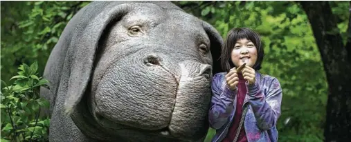  ?? Netflix photos ?? Mija (Seo-Hyun Ah) befriends Okja, a genetic freak of a pig developed by a malevolent company, in “Okja.”