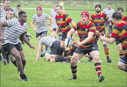  ?? ?? Ashford’s Ben Knight offloads to Jake Begg against Old Alleynians, and, below, Lewis Dempsey, Callum Stuckley and Farai Myezwa protect ruck ball