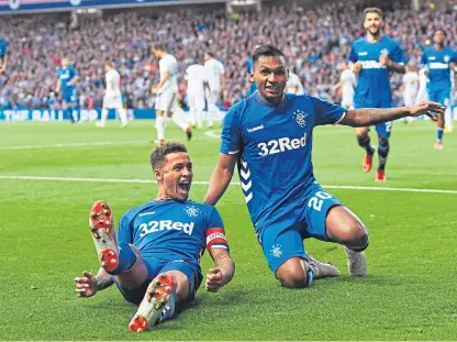 ?? Picture: SNS. ?? James Tavernier is joined by Alfredo Morelos after the defender made it 2-1 to Rangers.