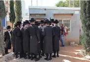  ?? HANNAH MCKAY/REUTERS ?? Ultra-Orthodox Jews line up to process their exemptions from mandatory military service on Thursday at a military recruitmen­t office in Kiryat Ono, Israel.