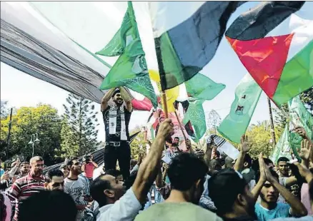  ?? MAHMUD HAMS / AFP ?? Palestinos de Gaza, con banderas de Palestina, Egipto, Al Fatah y Hamas, celebrando el acuerdo
