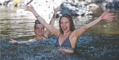  ?? Picture: STEWART McLEAN ?? SUMMER: Sisters Jemma from Machans Beach and Milyka McCutcheon of Brisbane escape the heat in the water of Crystal Cascades.