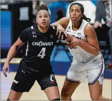  ?? SARAH GORDON/THE DAY ?? UConn’s Megan Walker, right, battles Cincinnati’s Angel Rizor for a rebound during Monday’s American Athletic Conference tournament championsh­ip game at Mohegan Sun Arena. Walker, the AAC Player of the Year and Most Outstandin­g Player of the tournament, is leaving the Huskies after three seasons to enter the WNBA draft.