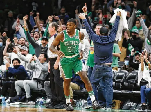  ?? WINSLOW TOWNSON/ASSOCIATED PRESS ?? Celtics fans cheer former All-star guard Joe Johnson after he made his one field-goal attempt — against the Cavaliers on Dec. 22 — during a brief stint as a replacemen­t player. More than 100 players were signed to short-term hardship contracts when NBA teams were decimated by the omicron variant.
