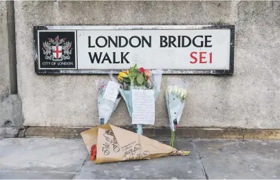  ?? Picture: EPA-EFE ?? MOURNING. Flowers and tributes near the crime scene at London Bridge. At least two members of the public died and a male suspect was shot dead by police after a stabbing at London Bridge on Friday.