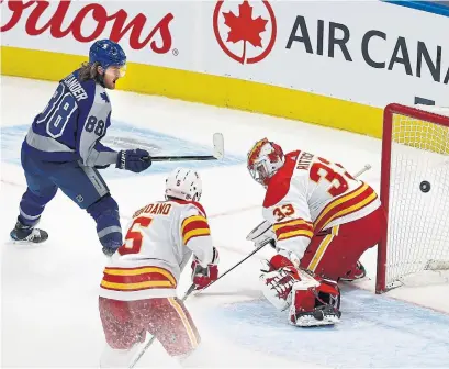  ?? RICHARD LAUTENS TORONTO STAR ?? Leafs forward William Nylander beats Calgary goaltender David Rittich in overtime to give the Leafs a 2-1 win Wednesday.