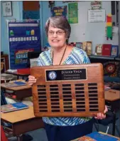  ?? WILLIAM HARVEY/RIVER VALLEY & OZARK EDITION ?? Junior Vega, a third-grade teacher at St. John Catholic School in Russellvil­le, holds the plaque she received as the first recipient of the St. John Catholic School Distinguis­hed Alumni Award, which has been named for her. Vega, who has taught 47 years...