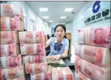  ?? XU JINBAI / FOR CHINA DAILY ?? An employee counts banknotes at a China Constructi­on Bank branch in Nantong, Jiangsu province.