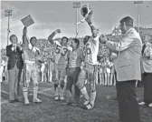  ?? ASU MEDIA RELATIONS ?? ASU coach Frank Kush and his players celebrate their 1975 Fiesta Bowl win over Nebraska, capping a 12-0 season.