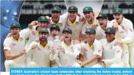  ??  ?? SYDNEY: Australia’s cricket team celebrates after retaining the Ashes trophy, defeating England on the final day of the fifth Ashes cricket Test match at the SCG in Sydney yesterday. — AFP