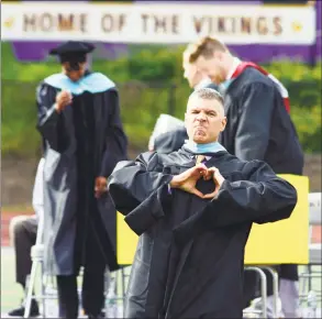  ?? Matthew Brown / Hearst Connecticu­t Media ?? Principal Michael Rinaldi makes a heart gesture to graduates at Westhill High School Class of 2018 commenceme­nt exercises on June 22 in Stamford.