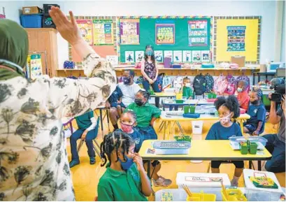  ?? JERRY JACKSON/BALTIMORE SUN ?? Teacher Rihab Rishak talks to her kindergart­en students in the Arabic language immersion program at Baltimore Internatio­nal Academy East on the first day of school.