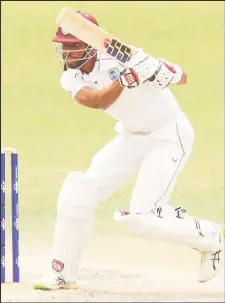  ?? ?? All-rounder Roston Chase celebrates his 10th Test fifty on the final day of the first
Test against Australia.