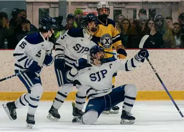  ?? MATTHEW J. LEE/GLOBE STAFF ?? St. John’s Prep captain Christian Rosa (foregound) celebrates his goal against Xaverian during the first period of a Division 1 semifinal at Loring Arena.