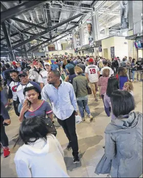  ?? COMPTON/CCOMPTON@AJC.COM CURTIS ?? Atlanta Braves fans take in all the choices for food during the Major League Baseball exhibition game against the New York Yankees for the soft opening of SunTrust Park on March 31 in Atlanta.