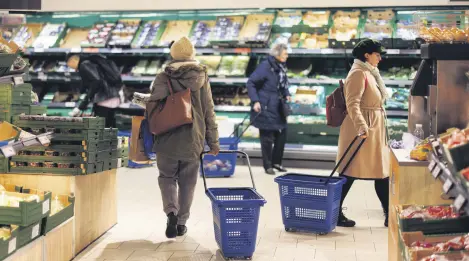  ?? ?? Customers shop for groceries at a supermarke­t in London, Britain, Feb. 27, 2024.