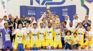  ?? Supplied photo ?? The victorious Al Taher players celebrate with the trophy and medals. —