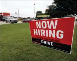  ?? ROGELIO V. SOLIS — THE ASSOCIATED PRESS FILE ?? A bilingual help wanted sign for Auto Zone, a retailer of aftermarke­t automotive parts and accessorie­s, is posted outside the store in Canton, Miss. The U.S. unemployme­nt rate fell in September to 3.7 percent, the lowest since 1969.