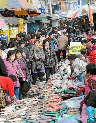  ??  ?? the Jagalchi Fish Market in Busan, South Korea’s largest seafood market.