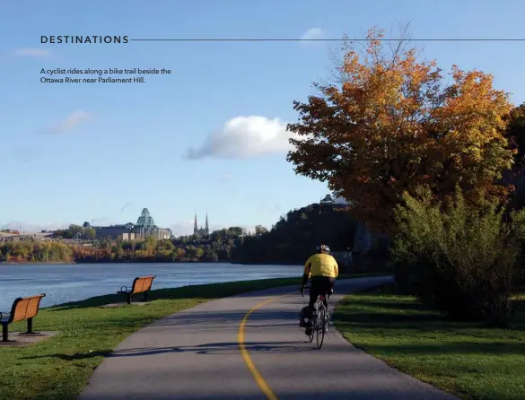  ??  ?? A cyclist rides along a bike trail beside the Ottawa River near Parliament Hill.