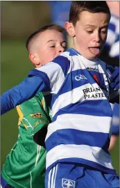  ??  ?? Conor McNally of Blessingto­n is tracked by Toby Miley, Dunlavin.