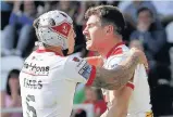  ??  ?? MARK OF GENIUS Percival (right) celebrates with Theo Fages after going over for St Helens