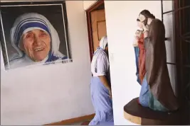  ?? CARLOS GONZALEZ — THE ASSOCIATED PRESS ?? A sister of the Missionari­es of Charity order, one of the 18nuns expelled last year from Nicaragua, walks past a poster of St. Teresa of Calcutta, in a parish home in Las Canas, Costa Rica, on March 1, 2023. After more than 30years of serving in Nicaragua, the organizati­on was stripped of its legal status and its members were escorted to the Costa Rican border.