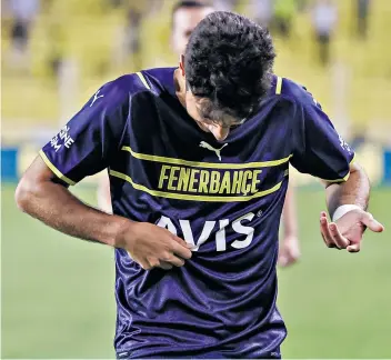  ??  ?? Where has it gone? Muhammed Gumuskaya searches for the Fenerbahce crest only to later find it is on the back of his new third-kit shirt