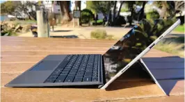  ??  ?? Microsoft’s Surface Pro 7+ in a more traditiona­l recline, where the narrow kickstand is visible. Note how the Type Cover’s hinge folds where it meets the keyboard. Visible are the Surface Connector slot and the USB Type A and Type C port.