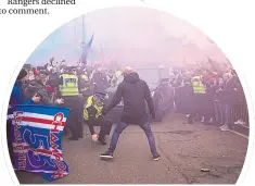  ??  ?? Policeman falls dealing with Ibrox crowd yesterday