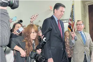  ??  ?? LONG DAY AT THE OFFICE: Former FBI Director James Comey is followed by reporters following his appearance before a closeddoor hearing with the House Judiciary and House Oversight committees on Friday.