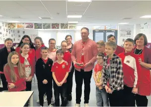  ??  ?? Morgan pictured with the Year 7 food and nutrition class and teacher Angela Townsend