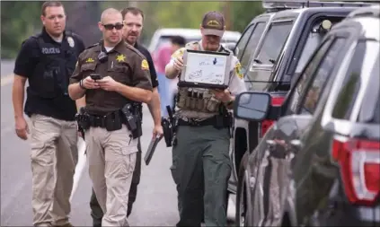  ??  ?? Investigat­ors from multiple agencies try to determine where shots fired truck originated from in Fruit Heights, Utah, on Monday. SCOTT G WINTERTON/THE DESERET NEWS VIA AP