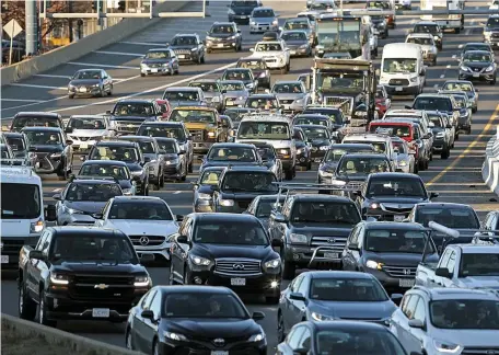  ?? MATT STONE / HERALD STAFF ?? EASY DOES IT: Traffic on the Southeast Expressway on Thursday is bumper to bumper, as always.