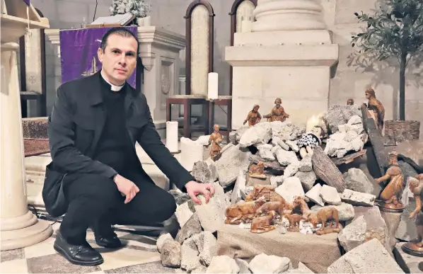  ?? ?? Rev Munther Isaac, pastor at Christmas Evangelica­l Lutheran Church in Bethlehem, installed a nativity scene in the form of a baby in the middle of a pile of rubble and debris, symbolisin­g Israeli bombing of Gaza