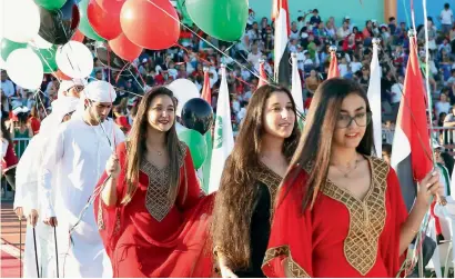  ?? File photo ?? Students dressed up in traditiona­l attire holding UAE flag-coloured balloons as part of last year’s National Day celebratio­ns. —