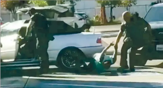  ?? COURTESY JOSH GIL ?? Video shows a San Jose police officer dragging a woman in a McDonald’s parking lot.