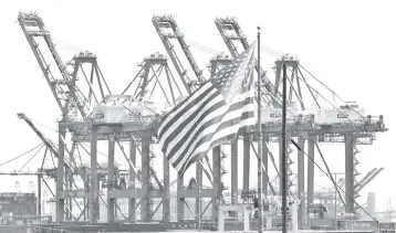  ??  ?? The US flag flies at the Port of Long Beach, in Los Angeles County The ISM’s non-manufactur­ing index jumped three points to 59.7 per cent from 56.7 per cent in the prior month, well above the consensus estimate of economists and above the 12-month average. Anything above 50 per cent indicates growth. — AFP photo
