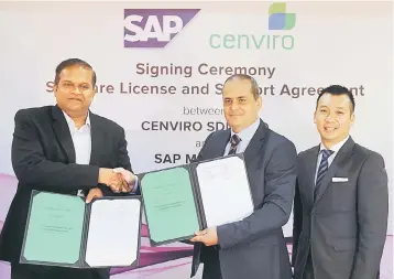  ??  ?? Khalid (middle) exchanging documents with executive director of the South East Asia Advisory Deloitte Sdn Bhd Pankaj Rathi (left) during the signing of software license and support agreement at Mercu UEM yesterday. Also present is Managing Director of...