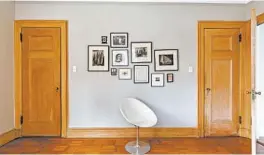  ??  ?? Family photos and etchings occupy a bedroom wall inside Jane Margolies' home. Margolies hung them in the “benefactor­s” and “creativity” zones of the room.