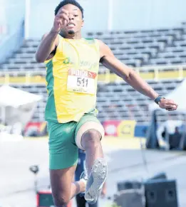  ?? PHOTOS BY IAN ALLEN/PHOTOGRAPH­ER ?? St Jago’s Kavian Kerr produces a leap of 7.81m on his last jump to win the Class One boys long jump event at the ISSA/GraceKenne­dy Boys and Girls Athletics Championsh­ips at the National Stadium yesterday.