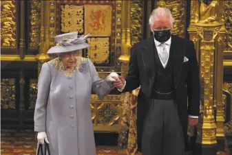  ?? Chris Jackson / Associated Press ?? Britain’s Queen Elizabeth II, with Prince Charles, departs after delivering a speech in the House of Lords during the opening of Parliament at the Palace of Westminste­r in London.