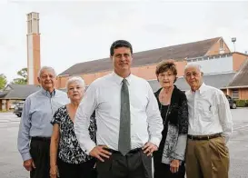  ??  ?? Bethany United Methodist pastor Dan Jones, center, is joined by, from left, Jim and Marge Roberts and Sue and Paul Ofield, members who are in favor of the proposed complex, which would reserve half the units for seniors on fixed incomes.