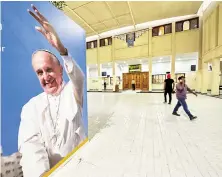  ?? Reuters ?? Welcome banners are displayed at the Sacred Heart Catholic Church, one of the places Pope Francis will be visiting during his Bahrain visit.